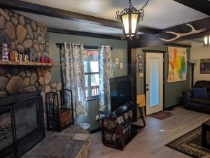 a living room with a fireplace and a stone wall at Serene A-frame Cabin Pet Friendly Panoramic View in Sun Valley