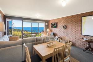 a living room with a couch and a table at Viewpoint in Tathra