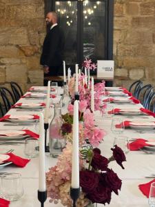 a long table with white candles and flowers on it at The Berrima Vault House in Berrima
