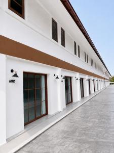 a row of windows on the side of a white building at Vanda Resort & Villa in Ban Thai Don (1)