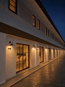 a building with a row of windows at night at Vanda Resort & Villa in Ban Thai Don (1)