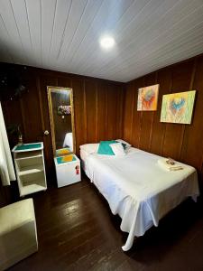 a bedroom with two beds and a mirror at Recanto do Sol I in Ilha do Mel