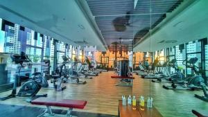 a gym with rows of treadmills and exercise bikes at 38 Romantic Studio Meritus Prai in Perai