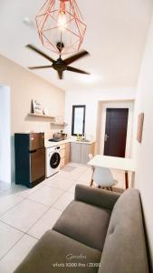 a living room with a couch and a ceiling fan at 38 Romantic Studio Meritus Prai in Perai +6 photos