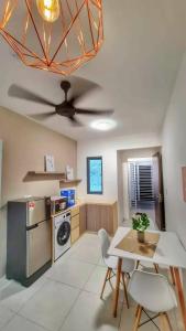 a kitchen with a table and a ceiling fan at 38 Romantic Studio Meritus Prai in Perai