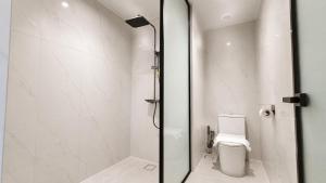 a bathroom with a shower and a toilet at H&H Boutique Hotel in Cukai +29 photos