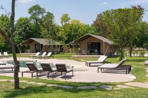 a group of chairs and tents in a park at Glamping Tenuta Ca'Nova in Mestrino