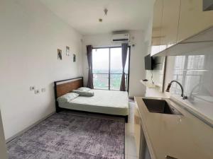 a small room with a bed and a window at Sky House BSD By Micky Studio in Cilenggang