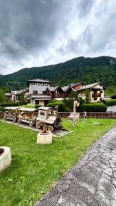 a group of trucks parked in a field with houses at La Casina - Centro Colere - 600mt dagli impianti in Colere
