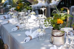 a long table with wine glasses and flowers on it at Laughing Horse Lodge in Bigfork