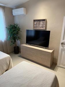 a living room with a large flat screen tv at Casa MarEscondido in Puerto Escondido