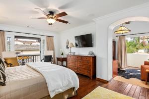 a bedroom with a bed and a ceiling fan at La Vida Riviera in Santa Barbara