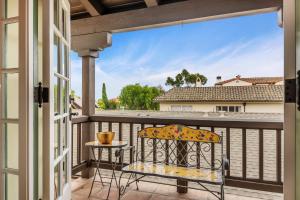 a balcony with a chair and a view of a building at La Vida Riviera in Santa Barbara