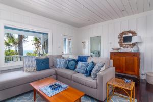 a living room with a couch and a table at Lillie by the Sea in Summerland