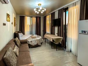 a living room with a couch and a dining room at Hotel Nika in Batumi