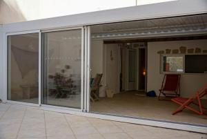 a sliding glass door on a patio at Au coeur de Leucate in Leucate +26 photos