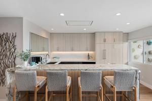 a kitchen with a large island with chairs around it at Carpinteria Shores CS 105 in Carpinteria +15 photos