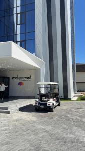 a golf cart parked in front of a building at Ilshat mini hotel in Cholpon-Ata