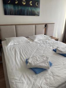 a white bed with two towels on top of it at Ilshat mini hotel in Cholpon-Ata
