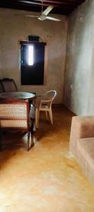 a room with a table and a chair and a tv at Lola House in Lamu