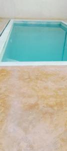 an empty swimming pool with a wooden floor at Lola House in Lamu +28 photos
