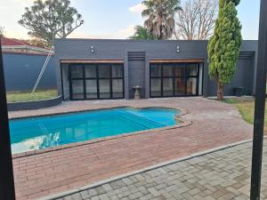 a swimming pool in front of a house at 47 Northward BnB in Newcastle