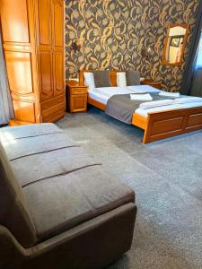 a bedroom with two beds and a chair in it at Guest house Elora in Chiflik