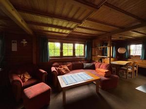 a living room with a couch and a table at Feriendomizil Haus Störtebeker in Spieka-Neufeld