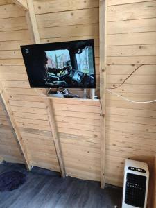 a tv in a room with a wall at Vikendica Hećo in Višegrad