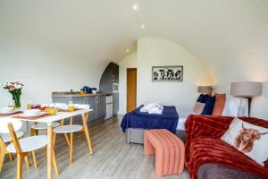 a room with a bed and a table with a couch at 2 Bed in Corwen oc-80318 in Gwyddelwern
