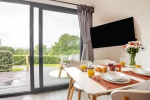a dining room with a table and a large sliding glass door at 2 Bed in Corwen oc-80318 in Gwyddelwern