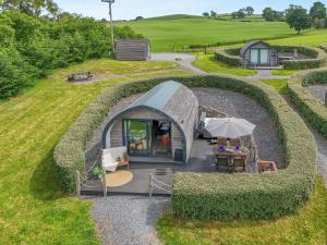 a small tent with a table and an umbrella at 2 Bed in Corwen oc-80318 in Gwyddelwern