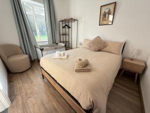 a bedroom with a bed with towels on it at The Old Post Office Cottage in Castlebar