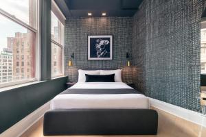 a bedroom with a large bed in a room with windows at Madison Square Studio at Return Policy Broadway in New York