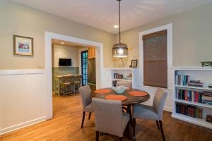 a dining room with a wooden table and chairs at Magnolia Cottage in Santa Barbara
