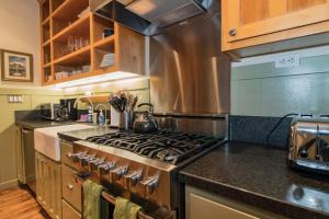 a kitchen with a stove and a counter top at Magnolia Cottage in Santa Barbara