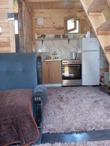 a kitchen with a bed in a tiny house at Vikendica Hećo in Višegrad