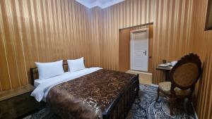 a hotel room with a bed and a chair at Retro Silent Boutique Hotel in Baku