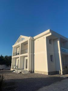 a large white building on a clear day at Villa SkyWay in Krujë
