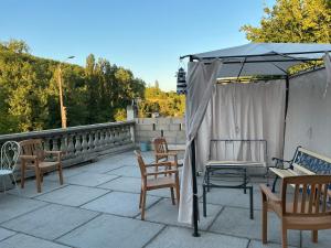 a patio with chairs and a gazebo at Chambres du Causse in Saint-Cernin-de-Larche