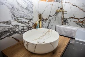 a bathroom with a bowl sink on a wooden table at Cabana The One in Beliş +51 photos