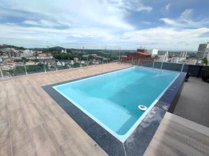 a swimming pool on the roof of a building at Studio in Barbacena
