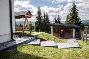 a house with a gazebo and a building at Cabana The One in Beliş