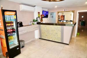 a bar in a restaurant with a refrigerator at Hotel Lua Origenes Rodadero, Santa Marta in Santa Marta