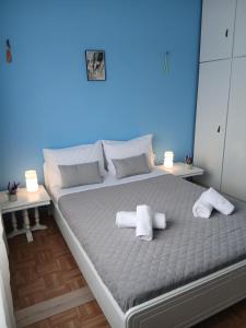 a bedroom with a large bed with towels on it at Chrysafenia's House in Mandrákion