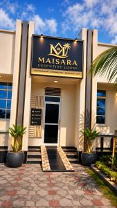 a building with a sign for a masarna associative lodge at Maisara lodge in Kilindoni