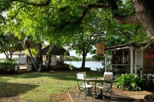 a picnic table and chairs in front of a house at Harmonie in Rivière Noire