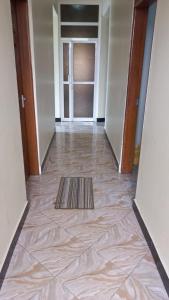 a hallway with a tile floor and a door at Maisara lodge in Kilindoni