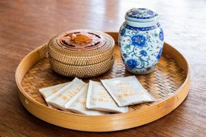 a basket with a blue and white vase and napkins at Takeno-an in Mitaka