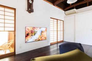 a living room with a large painting on the wall at Takeno-an in Mitaka
